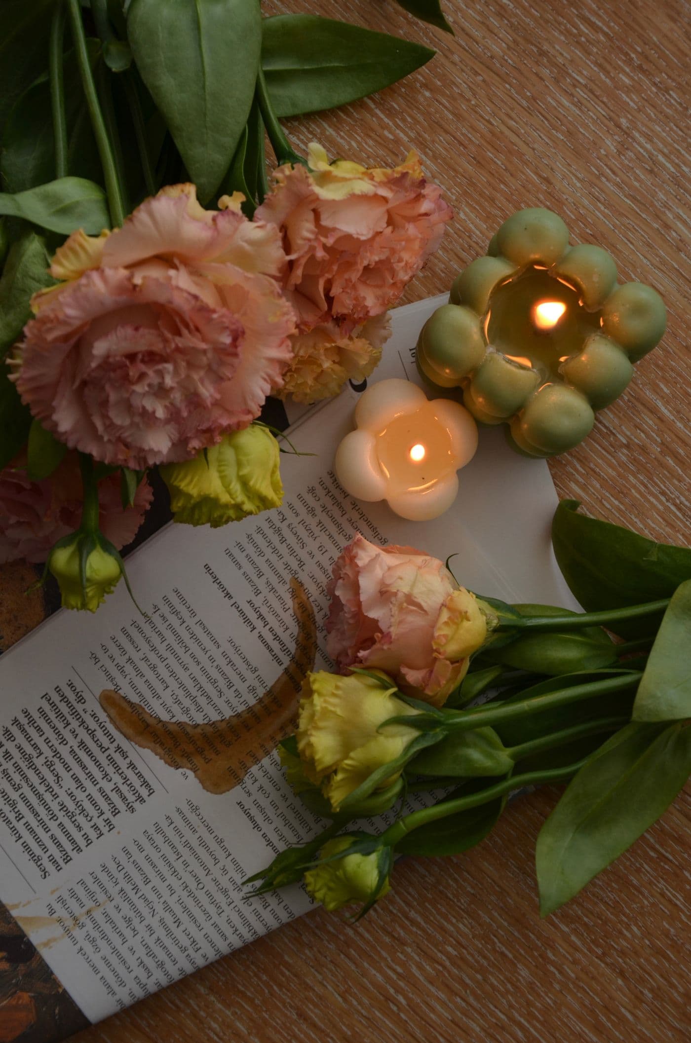 Hand-poured candles arranged with fresh flowers